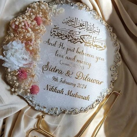 "These are personalized luxery handmade resin nikkah frames, wedding frames, engagement frames with customized design and print as per your requirements and demand including the phrases, names, dates etc. Arabic calligraphy prints are also available. Can be made in any colour of your choice Size: 10\" diameter / 25cm diameter   Package includes metal stand to display this gorgeous art piece.   Please include the following while placing your order: - Base color  (White, black, beige, red) - Flakes color (gold, silver, or copper) - Dried, pressed  flower or Rose petals (If required) - Color of text (Gold, Silver, Black) - Text details and its layout how you want. (Arabic/English?) name, dates Please note:  As our products are handmade, each one can differ from the other and has its own uniqu Resin Art Gift For Him, Couple Resin Art, Wedding Frame Design, Engagement Ring Plate, Nikkah Frame, Personalized Wedding Gifts For Couple, Wedding Ring Plate, Frame Anniversary Gift, Engagement Frame