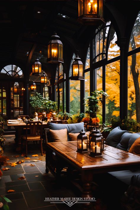 Experience the rustic charm of this farmhouse-inspired enclosed porch with large beautiful windows and a moody autumn aesthetic ✨🪴 The charming wood furniture and farmhouse lighting create a cozy haven, while the rustic potted plants breathe life into this enchanting space 🏡🌿#RusticFarmhousePorch #CharmingInteriors #InteriorDesignInspo #NaturalBeauty #CozyEscape #HomeDecorDreams #FarmhouseCharm #CountrysideLiving #WoodenFurniture #RusticElegance Dark And Moody Outdoor Space, Moody Autumn Aesthetic, Autumn Cafe Aesthetic, Moody Porch, Eclectic Front Porch, Moody Patio, Moody Sunroom, Rustic Home Aesthetic, Moody Eclectic Decor