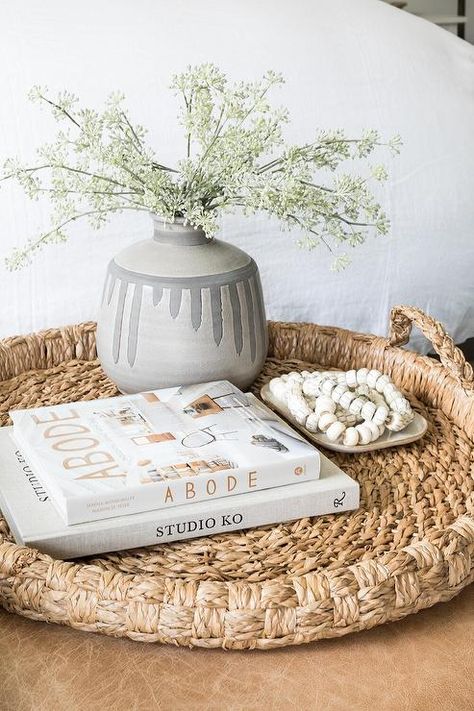 A round seagrass tray is styled and placed atop a brown leather ottoman. Ottoman Tray Decor Ideas, Ottoman Tray Decor, Brown Leather Ottoman, Pure Salt Interiors, Pure Salt, Apartment Decorating On A Budget, Ottoman Decor, Tray Styling, Ottoman Styling