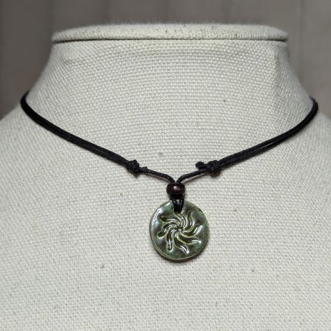 Earth Toned Green Ceramic Pendant Handmade Spiral Swirl Sun Burst Charm Boho Gothic Whimsigoth Hippie Adjustable Black Rope Cord Choker Stacking Necklace Comes On An Adjustable Waxed Black Cord Necklace. Necklace Is Adjustable From Approximately 13" To 22". To Wear Your Necklace Pull The Two Knots Away From The Pendant To Adjust To A Larger Size, Leave About An Inch Of Space Between The Two Knots To Prevent It From Getting Stuck. Put Cord Around Your Neck And Pull The Two Knots In The Opposite Direction To Adjust To A Smaller Size. Handmade Enamel Jewelry, Ceramic Necklace Pendant, Earthy Gifts, Ceramics Pendant, Whimsigoth Jewelry, Clay Necklace Pendant, Pottery Necklace, Earthy Necklace, Stacking Necklace