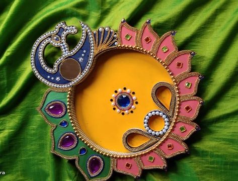 It's a wooden plate painted with acrylic colours and decorated over with rhinestones and gems .it's a sort of decorative piece especially used for religious rituals and pooja in Indian families . Very easy to create Wooden Pooja Thali Decoration Ideas, Pooja Thali Decoration Ideas, Arti Thali Decoration, Arti Thali, Doll Cake Designs, Aarti Thali, Puja Thali, Decorate Ideas, Thali Decoration