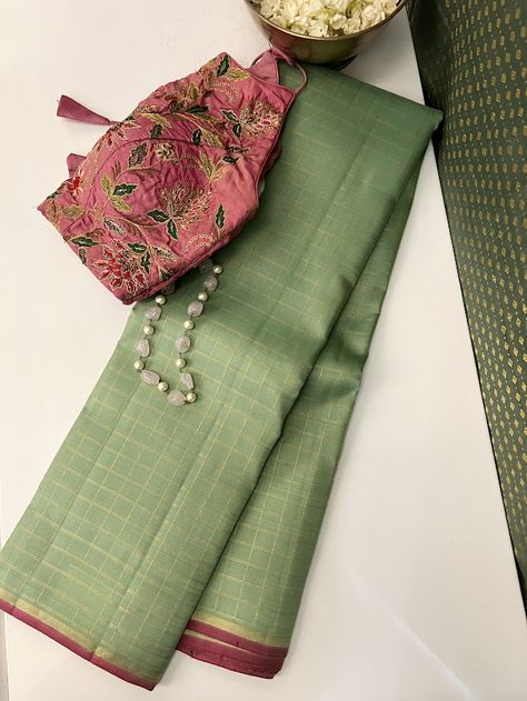 Our signature color combination, cardamom green and pink, finally debuts in the Charita style. Sink your eyes into this pure handloom kanchipuram silk saree with pure zari checked body with pink accents and witness how simplicity and opulence seamlessly merge in this exquisite drape. The pink and zari selvedge and zari striped pink pallu are the perfect accents to the cardomom green body. Pick one of very many of our blouses to pair beautifully with it or use the pink blouse that comes with the saree, either way, you are gaunrateed a stunning look. Kanchipuram Green Saree, Different Colour Combinations In Sarees, Pink Blouse Green Saree, Saree And Blouse Color Combinations, Green Contrast Color Combinations, Color Contrast Combination, Saree Colour Combination, Saree Pallu Design, Sarees Combination