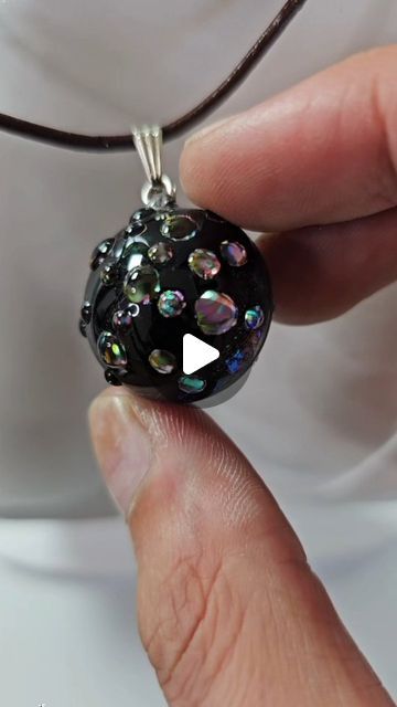 Daniel Cooper on Instagram: "Wait until you see this finished! 🤯😍

Creating a unique resin art jewelry piece using resin.

I created two clear half spheres and bonded them together with some Dicro-ISH film from Little-windows.

I then sanded to allow the spray paint to bond. I used liquid latex to mask the areas I wanted clear to allow the light and color of the film to show through.

I then peeled away the latex and dipped into clear uv resin.

To finish it off, I added uv resin dots to the clear windows which intensify the light and color and gives the resin pendant more dimension.

I absolutely love how this piece came out!

Resin art, viral, resin, resin art jewelry, resin jewelry, jewelry making, jewelry artist.

#resinart #resin #jewelrymaking" Resin Art Jewelry, Liquid Latex, Jewelry Artist, Clear Windows, Jewelry Resin, Resin Pendant, Uv Resin, Artistic Jewelry, Art Jewelry