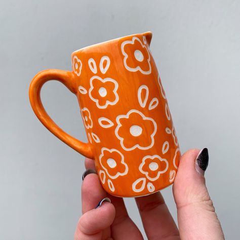 Totally forgot to post this little orange jug that sold a while back, such a pretty colour! ✨🧡🍊 Lots of other ceramics are available on my website now, link in bio 🥰✨ #art #artist #ceramics #pottery #painting #illustrator #ceramicstudio #potterytiktok #potterypainting #painter #potteryart #ceramicpainter #floral #bisqueware #glaze #glazedip #creative #smallbusiness #smallbusinessowner #smallartist #floral #plate #potterylove #decor #botanical #botanicalart #potteryprocess #potteryfeature #p... Pottery Painting Jug, Jug Painting Ideas, Vase Pottery Painting Ideas, Pottery Vase Painting Ideas, Clay Cafe, Diy Pottery Painting, Pottery Inspo, Color Me Mine, Cerámica Ideas