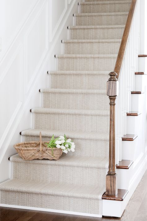 Get all the details for a DIY stair runner project with cost efficient, easy to clean stair runner rugs! Use an indoor outdoor runner for a look you're going to love. Find sources for modern stair runners and get a complete tutorial for how to accomplish this DIY in your own home - it's easier than you might think! As it turns out, the inexpensive solution for making over your old staircase may fit in your budget and your design dreams, too! You'll find pretty and practical ideas in this diy Staircase Runner Rug, Diy Stair Rug Runner, Stairs With Runner And Rods, Neutral Runner Stairs, Stairs Runners Ideas, Carpeted Stairs To Wood Transition, White Oak Stairs With Runner, Stairwell Runner Ideas, Plain Stair Runner