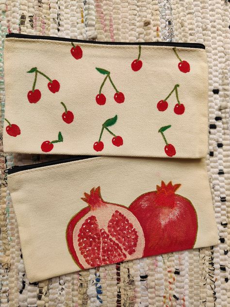 *Handpainted canvas pouches with pomegranate and cherries designs, perfect for gifts. *12x21cm ideal as a pencil case, accessories or makeup case. *Handpainted with acrylic, gouache and fabric medium* and finished with acrylic markers  *this should make the purse washable but gentle hand washing is recommended if necessary Pencil Case Painting Ideas Aesthetic, Pencil Case Design Diy, Cute Pencil Case Design, Drawing On Pencil Case, Pencil Case Design Ideas, Makeup Bag Painting Ideas, Pencil Case Drawing Ideas, Canvas Pencil Case Design, Pencil Pouch Painting Ideas