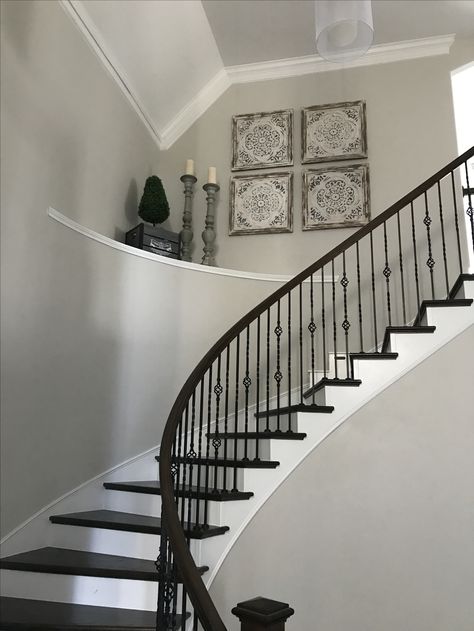 Decorate large high ceiling curved stairs shelf large entryway Curved Stair Wall Decor, Stair Shelf Decor, Staircase Ledge Decor Ideas, High Ceiling Stairway Decor, Curved Staircase Wall Decor, Entryway Ledge, Foyer Ledge, Foyer Shelf, Stair Shelf