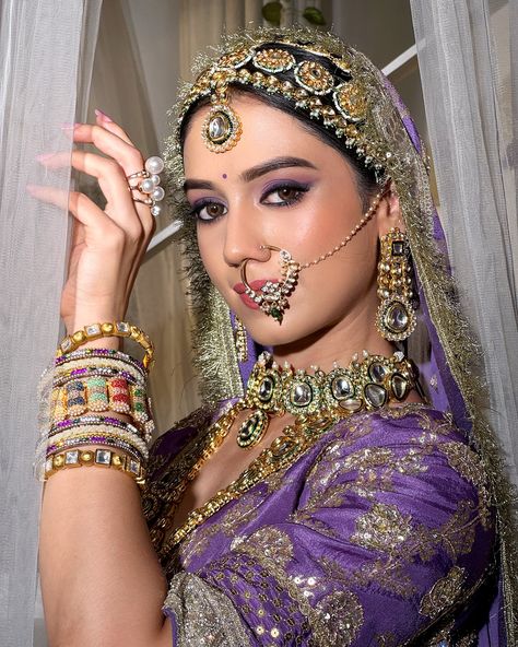 𝗣𝗿𝗲𝘀𝗲𝗻𝘁𝗶𝗻𝗴 𝗥𝗲𝗸𝗵𝗮 𝗠𝗮𝗻𝗴𝗮𝗹’𝘀 𝗕𝗿𝗶𝗱𝗲 💜 The Maharani Look—a celebration of heritage, power, and elegance. This timeless bridal look embraces minimalism, with makeup that highlights the natural beauty of the bride. The eyes are the focal point, adorned with a striking blend of purple and violet gradation, creating a bold yet graceful statement. Complemented by soft, pink nude lips, this look captures regal sophistication, perfect for the modern-day queen.👸 👑 (Bridal makeup, indore makeup artist, l... Maharani Look, Indian Makeup Looks, Purple Lehenga, Purple Saree, Nude Lips, Purple Eyeshadow, Indian Makeup, Bridal Look, Indian Bride