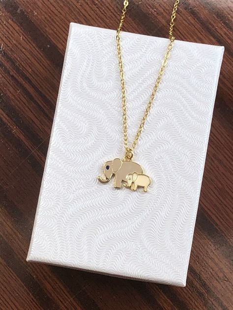 925 Sterling Silver Mom and Baby Elephant Pendant Necklace   - Metal: 925 Sterling Silver (Finish: Yellow Gold Plated) - Stone: Lab-Created Royal Blue Gemstone, Cream Ceramic  - Shape: Two Elephants - Pendant Dimension: 14mm(0.55 in) x 8mm(0.31 in) x 1mm  (Big Elephant 12mm (0.47 in) x 8mm(0.31 in), Small Elephant 7mm (0.28 in) x 5mm(0.20 in.)  - Light Cable Chain: 18" Adjustable (16" + 1" + 1"), Lobster Clasp - Color: Gold Pretty Gold Necklaces, Elephant Necklace Gold, Two Elephants, Mom And Baby Elephant, Biggest Elephant, Elephant Pendant Necklace, Lotus Jewelry, Small Elephant, Elephant Lover