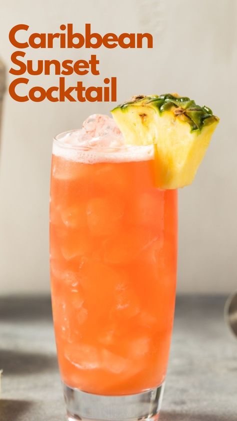 Do you dream of relaxing on a Caribbean beach, watching the sun nestle behind the captivating ocean, but are stuck in any place but there? Then a Caribbean Sunset cocktail may be the answer to your dream. This incredibly light rum drink is effortless to make. Just combine your favorite coconut rum with pineapple juice, a dash of lime juice, and grenadine for aesthetics, and off you drift into your tropical fantasy. #CaribbeanSunsetCocktail Coconut Rum And Pineapple Juice Drinks, Rum Drinks With Pineapple Juice, Light Liquor Drinks, Caribbean Sunset Cocktail, Caribbean Drinks Nonalcoholic, Rum Pineapple Cocktail, Carribean Drinks Cocktails, Tropical Sunrise Drink, Mango Rum Drinks Recipes