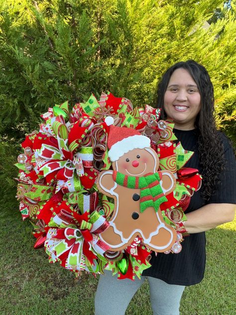 This charming Gingerbread Wreath is a delightful addition to your holiday decor. Each wreath is custom made to order, ensuring a unique and personal touch for your home. Adorned with festive mesh, ribbons, and bows, this wreath is further enhanced with a whimsical gingerbread sign that adds a touch of sweetness to any space. ‼️ Please note that ribbon patterns and colors may vary, but rest assured each wreath is crafted with care to capture the cozy spirit of the season.   🎀MADE TO ORDER🎀 I al Santa Clause Wreaths, Gingerbread Christmas Wreaths, Gingerbread Mesh Wreath, Candy Christmas Wreath, Christmas Cookie Wreath, Gingerbread Wreaths, Gingerbread Sign, Gingerbread Christmas Wreath, Cookie Wreath