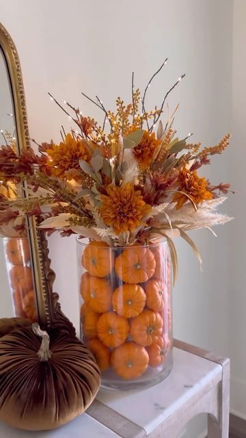 Ashley Savage | Creator | Atlanta, GA on Instagram: "🎃Pumpkin Display🎃SHARE & SAVE this one for later! When mini pumpkins come out at your local grocery store grab them and add them to a vase like this and add some fall florals including these beautiful lighted branches and I love how it turned out. Would be perfect to keep up all fall season long through thanksgiving! • • • #pumpkinseason #pumpkinarrangement #fallflorals #falldiy #thanksgiving #thanksgivingideas #falldecorideas #seasonaldecor #falldecoratingideas #diyhomedecor #pumpkindecor #pumpkin🎃 #cozydecor #houseandhome" Fall Decorations Inspiration, Pumpkin Filler Decor, Thanksgiving Decorations Entryway, Big Fall Flower Arrangements, Thanksgiving Pumpkin Centerpiece, Thanksgiving Bar Decor, Pumpkins In Vase Centerpiece, Fall Flowers Decorations, Fall Decor Ideas For The Home Shelves