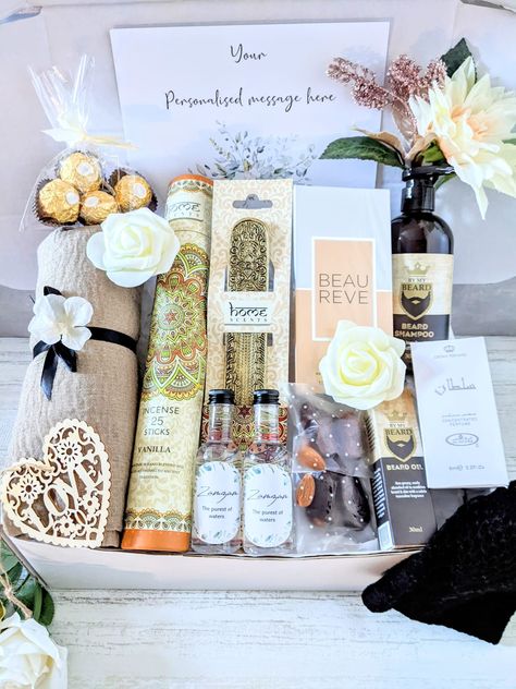 This gorgeous, luxury his and hers gift hamper makes the perfect gift for a couple on the occasion of their engagement, Nikah, wedding, bridal shower, anniversary, Ramadan, Eid,  etc.  The gift hamper contains: - Beige crinkle/crimp hijab, tied with satin ribbon and faux flower. An everyday essential. - 100 ml Perfume. - Black prayer hat. - Mens itr. - Beard Shampoo. Helps keep beard hair clean, soft and manageable. (300ml) Suitable for vegans - Beard oil. Non greasy, easily absorbed oil to cond Islamic Wedding Gift Hampers, Gift Hamper Styling, Wedding Hamper For Couple, Islamic Hamper, Itr Perfume, Nikkah Gifts, Wedding Hampers, Engagement Gift Baskets, Perfume Black