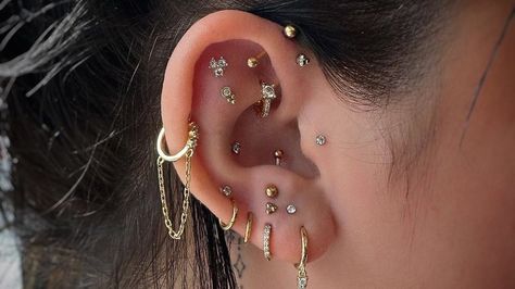 Piercings That Will Be Trendy in 2024 Ear Piercing Care, Triple Ear Piercing, Ear Piercing Combinations, New Ear Piercing, Mouth Piercings, Tragus Helix Piercing, Ear Peircings, Ear Piercings Chart, Piercing Chart