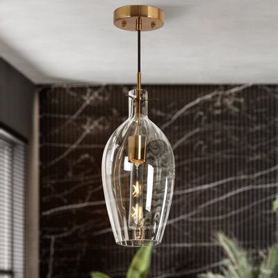 Clear glass accentuates its modern details with style and sophistication. A clear glass shade encloses the lone light bulb displayed by this steel mini pendant. Featuring an aged brass finish, this steel mini pendant exudes understated character. Its clear glass shade reinforces a streamlined personality. Offer a decorative touch to help illuminate your favorite decor with this subtle light fixture. | Breakwater Bay Meya 1 - Light Single Bell Pendant Glass | 18 H x 7 W x 7 D in | Wayfair Pendant Bathroom Lights, Two Pendant Lights Over Kitchen Island, Bathroom Pendant Lights Over Vanity, Bathroom Pendants, Mediterranean Interior Design, Unique Pendant Lights, Modern Pendant Lighting, Bathroom Pendant Lighting, Bathroom Pendant