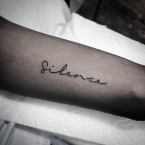 Word ‘silence’ inked on the arm in minimalist font Silence Tattoo, Simple Word Tattoos, Word Tattoos On Arm, Tattoo Son, Meaningful Wrist Tattoos, One Word Tattoos, Phrase Tattoos, Stick N Poke Tattoo, Hand Poked Tattoo