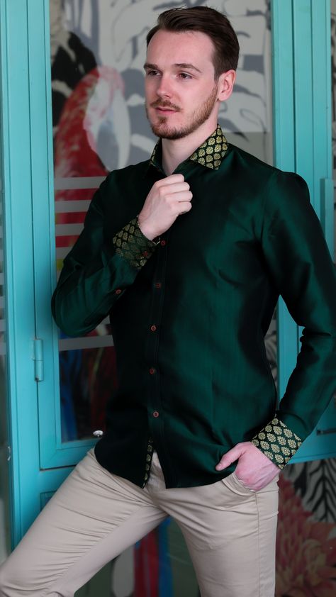 The forest is alive with the infusion of green color in this fine silk shirt. The deep green color of trees is composed across the canvas of the shirt while symmetrical gold leaf motifs featured in brocade are located on the cuff and collar.  This Silk Sense Fashion product uses Banaras brocade fabric for the shirt. It is a patterned textile that employs a second, special type of thread that is usually gold in color to create the pattern. IG and FB- @silksensefashion. Discover more in Etsy shop Silk Shirt Men Indian, Party Shirts For Men, Kit Launch, Green Silk Shirt, Party Shirts Men, Silk Shirt Men, Deep Green Color, Silk Shirts, Velvet Shirt