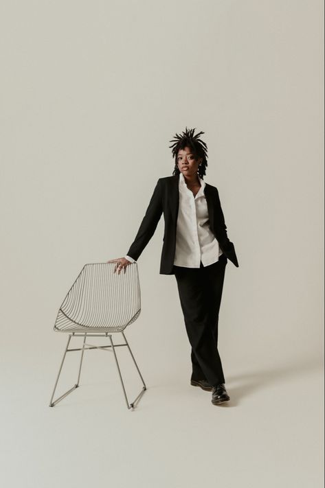 Black woman on locs wearing a suit and holding a chair in a studio photoshoot picture. Big Chair Photoshoot, Solo Photoshoot Ideas Studio, Chair Poses Women, Locs Photoshoot, Photoshoot Chair, Black Tomboy, Chair Photoshoot, Bday Hair, Website Aesthetic