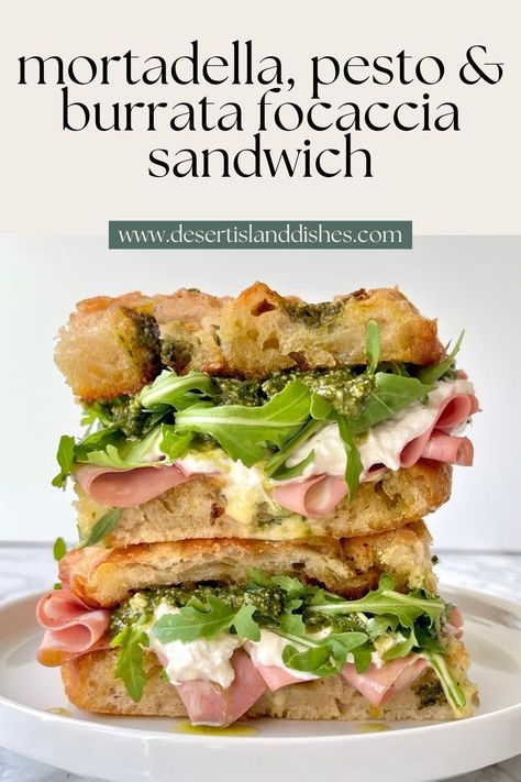 This easy focaccia sandwich has crisp pesto focaccia, pesto, burrata, mortadella, rocket and a homemade garlic confit aioli. Pesto Focaccia Sandwich, Focaccia Panini Sandwiches, Sandwiches With Focaccia Bread, Pesto Sourdough Sandwich, Cold Italian Sandwiches, Focaccia Sandwich Recipes, Faccocia Sandwich, Best Deli Sandwiches, Italian Focaccia Sandwich