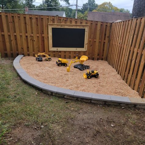 Outdoor gravel play area Corner Play Area Outdoor, Patio And Play Area Backyard Ideas, Inground Sandbox Ideas, Small Space Backyard Ideas For Kids, Backyard Digging Area, Backyard Construction Play Area, Boys Outdoor Play Area, Back Yard Kid Friendly Ideas Diy, Play Areas For Kids Outdoor