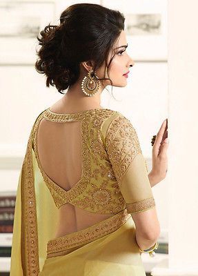 Beautiful saree blouse in yellow with golden embroidery | Please email at hello@wittyvows.com for credits | Peephole cutout blouse design with elbow length sleeves | Latest and trending saree blouse designs | Indian bridal fashion | Bridal couture | Prachi Desai | Bridal fashion | Trousseau | Couture |  #wittyvows #bridal #indianbride #blouses #bridetobe #fashion #couture #bridesmaids #bridalfashion #asianbride #bride #trousseau #style #trending #saree #prachidesai | ब्लाउज बैक नेक डिजाइन, Golden Blouse, Blouse Lehenga, Blouse Designs Catalogue, Sari Design, New Saree Blouse Designs, Backless Blouse Designs, Saree Blouse Neck Designs, Fashionable Saree Blouse Designs