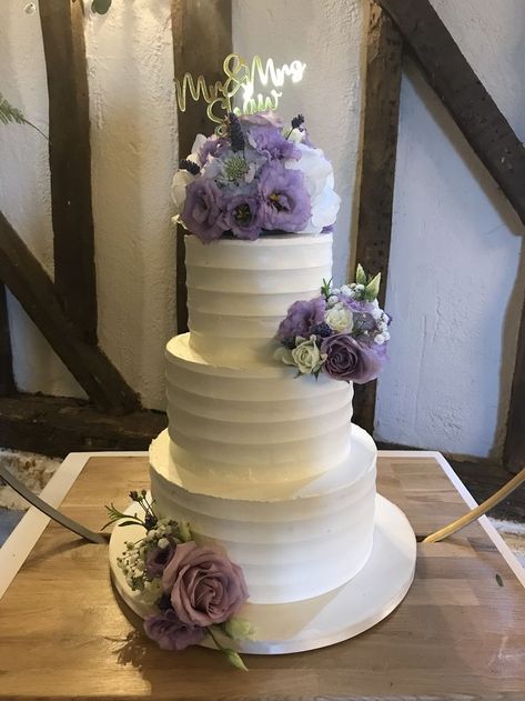 3 tier Buttercream frosted wedding cake decorated with fresh flowers in lavender & lilac plus gold personalised topper Frosted Wedding Cake, Wedding Cakes Lilac, Lavender Wedding Theme, Quince Cakes, 3 Tier Wedding Cake, Quince Cake, Lavender Cake, 3 Tier Wedding Cakes, Purple Wedding Cakes