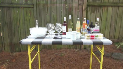 Dress Up a Folding Table Video | HGTV Decorate Folding Table, Diy Folding Table Makeover, Plastic Folding Table Makeover, Folding Table Makeover, Plastic Folding Table, Table Makeover, Folding Table, Spray Paint, Removable Wallpaper