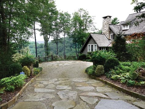 A driveway made up of gravel and large, irregularly shaped stones makes for a warm welcome at this property, plus sets an informal tone that’s appropriate for the cottage style of the home. Lush green plants line the driveway and harmonize with the wooded, mountainous surroundings. Wildflower Garden Ideas, Tutor House, House Driveway, Circle Driveway, Driveway Entrance Landscaping, Terraced Landscaping, Permeable Paving, Country Ranch, Stone Driveway