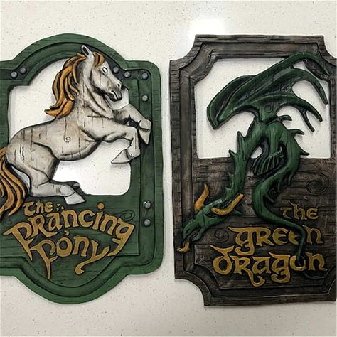 PRICES MAY VARY. 1.This inspired The Lord Of The Rings Prancing Pony is highly detailed and weathered to look screen accurate to the sign in the movie. Its the perfect memorabilia to hang in your own bar or house. 2.These 'The Prancing Pony' and 'The Green Dragon' pub signs are hand sculpted and detailed. They are cast in polyurethane resin and painted and weathered using acrylic and oil paints. 3.They measure at approximately 26cm in height, 17cm in width. There is also a ready attached hook su Lord Of The Rings Decor, Fantasy Diy, Prancing Pony, Funny Bar Signs, Dragon Wall Art, Dragon Horse, Handmade Bar, Dragon Wall, Pub Signs