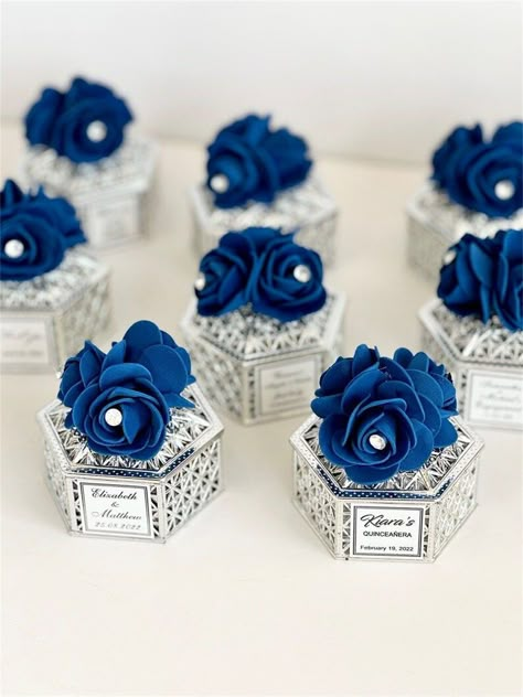 A wedding is a tapestry of love, woven together with unique details and personal touches. For couples seeking an unconventional yet timeless theme, the color blue offers a perfect palette to create an atmosphere of serenity, sophistication, and enduring love. Royal Blue And Silver Wedding Theme, Blue And Silver Wedding Theme, Royal Blue And Silver Quinceanera, Royal Blue Wedding Ideas, Royal Blue Wedding Favors, Royal Blue And Silver Wedding, Wedding Favors Boxes, Bride Shower Gifts, Royal Blue Wedding Theme