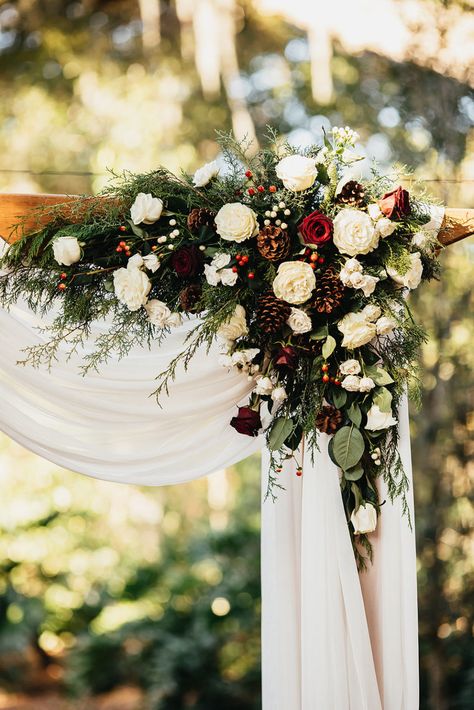 Rustic-Elegant Burgundy and Evergreen Holiday Inspired Wedding | Cross Creek Ranch - Marry Me Tampa Bay | Local, Real Wedding Inspiration & Vendor Recommendation & Reviews Winter Wedding Arch, Christmas Wedding Flowers, Evergreen Wedding, Rustic Winter Wedding, Winter Wedding Bouquet, Wedding Cross, Wedding Arch Flowers, Winter Wedding Decorations, Arch Flowers