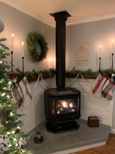 Wood Burning Stove Wood Storage, Christmas Wood Stove Decor, Stove Fireplace Decire, Christmas Decor Around Woodstove, Faux Wood Stove Surround, Wood Burning Stove Christmas Decor, Corner Stove Mantle, Word Burning Stove Ideas, Pot Belly Wood Stove