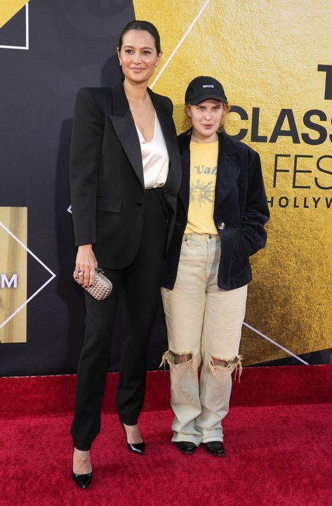 Bruce Willis’ Wife and Daughter Attend the "Pulp Fiction" 30th Anniversary on His Behalf and People Are Worried Tallulah Willis, Emma Heming, Black Pantsuit, Beige Blouse, 10th Wedding Anniversary, Sleek Bun, Four Kids, Bruce Willis, Yellow T Shirt