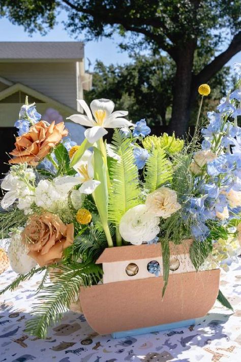 Feast your eyes on this stunning Noah's ark-themed baby shower! The floral centrepiece is wonderful!! See more party ideas and share yours at CatchMyParty.com Noahs Ark Shower Ideas, Diy Noah's Ark Boat, Noahs Arc First Birthday, Noah’s Arch Theme Birthday, Noahs Ark Party Theme, Noah's Ark Party Decorations, Noahs Ark Centerpiece Ideas, Noah’s Ark First Birthday, Noah's Ark Baby Shower Decorations