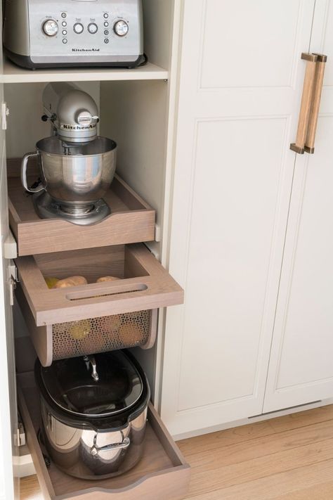 This appliance garage features pull-out shelves that can hold a toaster, mixer, crock pot, and more. Plus there is a pull-out produce drawer to keep vegetables hidden but fresh. Under the microwave, there is a hidden drawer with more storage for bread and rolls. Produce Drawer, Kitchen Appliance Garage, Studio Dearborn, Vegetable Drawer, Kitchen Appliance Storage, Appliance Cabinet, Appliance Garage, Hidden Drawer, Kitchen Tour