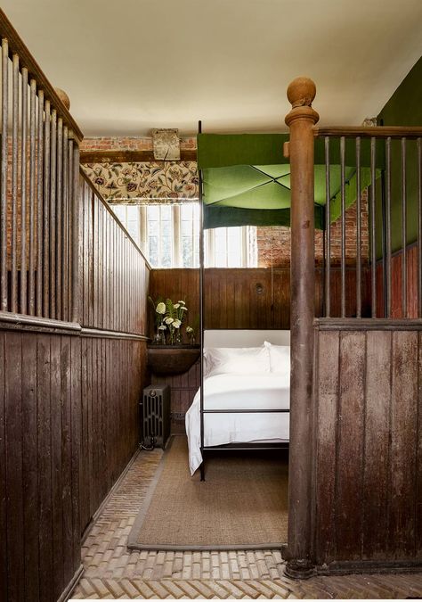 A corner manger has been converted into a slate-topped bedside table in this ground floor bedroom, which has its bathroom in an adjacent loosebox. The blind is in ‘Kashida’ by Zoffany – a crewelwork design in wool on heavy cotton, used in several of the bedrooms, and the iron four-poster is by Francis Russell. Dark Purple Walls, Stable Conversion, Chalet Design, St Giles, House Restoration, Floor Sitting, Farm Buildings, Large Dining Room, Barn Conversion