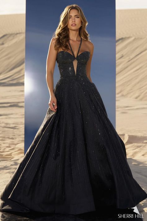 *Adds to Cart* Sherri Hill style 56815 is a showstopper, for sure! The shimmering hot fix ball gown features a fitted bodice with sheer keyhole detail. The straps give the illusion of a halter neckline, but actually criss cross in the back giving the bust some additional support. The sparkling heat stone embellishments adorn every element of the dress from the straps to the skirt, ensuring you'll be glistening all night long! Whether you're planning to wear it under the Friday night lights as you're crowned homecoming queen or while you take the crown at your next pageant, Sherri Hill 56815 is going to have every eye glued on you! Dress Shops, Homecoming Queen, Sherri Hill Prom, Princess Sleeves, Sherri Hill Prom Dresses, Prom Dress Stores, Prom Dress Styles, Prom Designs, Designer Prom Dresses