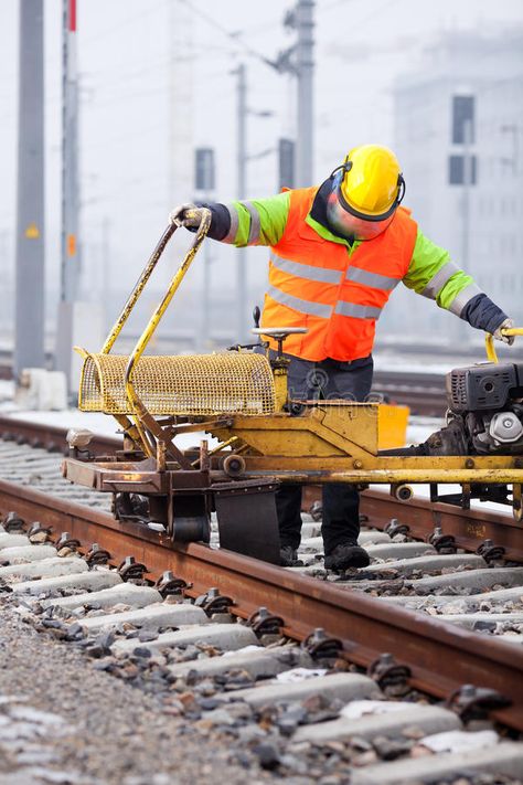 Repair the railtrack. A railroad worker grinds the rails with his machine #Sponsored , #ad, #Ad, #railtrack, #rails, #machine, #railroad Railroad Worker, Machine Image, Realistic Watercolor, Winter Images, Heavy Equipment, Stock Images, Repair, Train