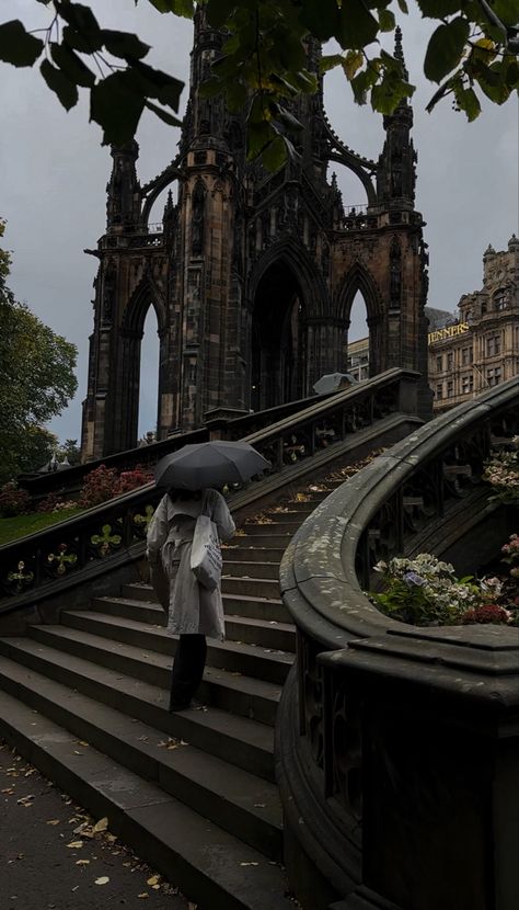 Girl with Trenchcoat and umbrella in Edinburgh walking upstairs in front of Scott monument Edinburgh Rain Aesthetic, Edinburgh City Aesthetic, Autumn In Edinburgh, Edingbruh Autumn, Edinburgh Autumn Aesthetic, English Autumn Aesthetic, Edinburgh Aesthetic Dark, Autumn Dark Aesthetic, Edinburgh Rain