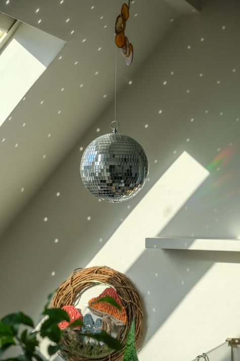 Need to fill your space with positive energy and a magical all natural light show.When placed in direct sunlight this Disco Ball will produce dancing sun reflection around your room.FAST SHIPPING - This item will deliver after the holidays1 Mirror Ball Per UnitCovered with Glass MirrorGreat for birthday parties, special events hall decorations and more!Perfect decor item you never knew you needed! Life is too short not to have fun with a disco ball in your space! Great gift for a friend who need Hanging Lights In Bedroom Ideas, Disco Ball On Ceiling, Disco Ball House Decor, Disco Ball Interior Design, Dorm Disco Ball, Disco Ball For Room, Mini Disco Ball Decor Bedroom, Disco Ball Lighting, Disco Ball Apartment Decor