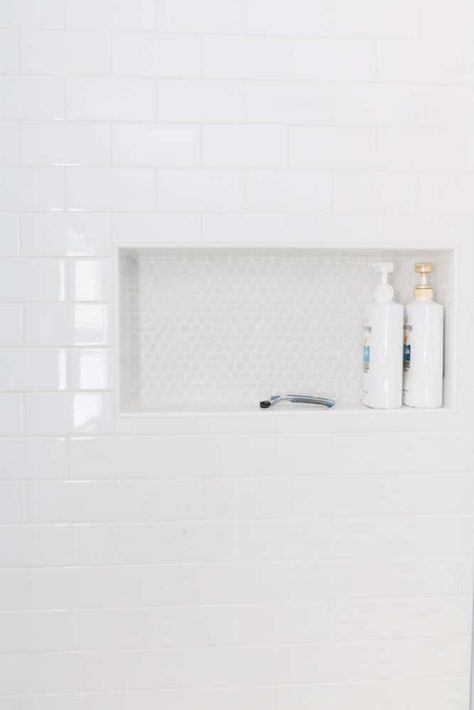 White Subway Tile Wainscoting Bathroom, White Subway Tile Niche, White Tile Bathroom Floor Ideas, Penny Tile Tub Surround, Marble And White Subway Tile Bathroom, White Subway Tile Shower With Penny Tile Floor, Penny Tile And Subway Tile Bathroom, White Subway Tile Bathtub Surround, All White Tile Bathroom