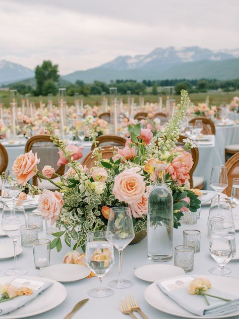 Pink peach rose, peach ranunculus, white delphinium, apricot tulips, peach lisianthus, white cosmos, pink coral garden rose, feverfew chamomile - gold bowl - round table centerpiece Coral Pink And Gold Wedding, Peach And White Wedding Centerpieces, Peach And Pink Floral Centerpieces, Round Table Garden Party, Wedding Florals Round Table, Ranunculus Centerpiece Wedding, Wedding Floral Centerpieces Round Table, Wedding Round Table Flowers, Apricot Tulips