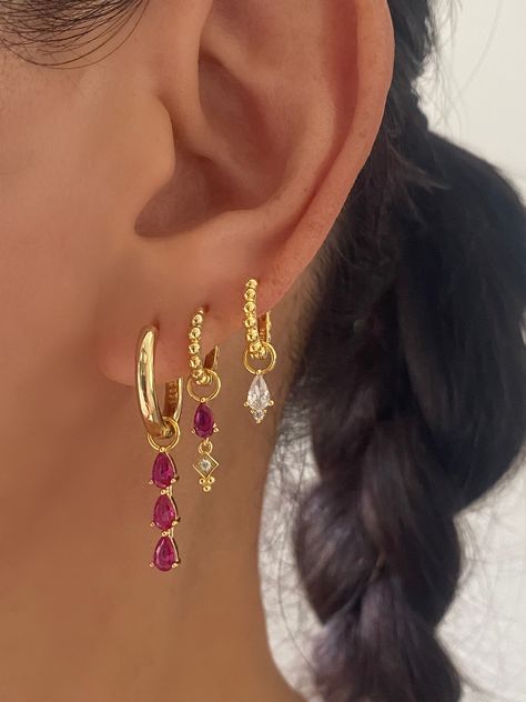 This gorgeous set comes with • 1 Pair of 3 Teardrop Pink charm with 17mm Hoop Material: 18k Gold plated on 925 sterling silver, AAAAA Cubic Zirconia • 1 Pair of Pink Teardrop charm with 15mm Princess Hoop Material: 18k Gold plated on 925 sterling silver, Cubic Zirconia • 1 Pair of Single Clear charm with 12mm Princess Hoop Material: 18k Gold plated on 925 sterling silver, AAAAA Cubic Zirconia • 1 Anett Gift Box HypoallergenicNickel free and Lead free Pink Earring Stack, Cool Gold Earrings, Pink Earrings Aesthetic, Dangly Earrings Aesthetic, Earring Stack Ideas, Jewelry Colourful, Earring Stacks, Jewel Earrings, Piercing Inspo