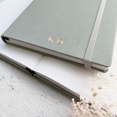 Our grey dot grid notebook with white dotted paper (also available with plain or lined paper) is perfect for bullet journaling, notes, line drawings, to-do-lists and more. A5 in size and in soft vegan leather, they make a sophisticated gift for a new job, promotion, birthday, anniversary or special occasion. Personalise with initials, a monogram or short name. #journal #notebook #planner #personalised #stationery #notepad Notebook Photography, Notebook Personalised, Embossed Notebook, Personalised Stationery, Monogram Notebook, Dotted Paper, Personalised Keyrings, Foil Printing, Dot Grid Journal