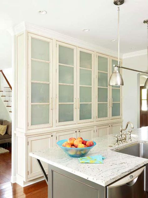 Both a storage wall and a style statement, this wall of floor-to-ceiling cabinetry creates a breezy separation between the front entry and the kitchen. The frosted-glass inserts on the upper cabinets also help the divider look more airy. Kitchen Cabinets To Ceiling, Cabinets To Ceiling, Floor To Ceiling Cabinets, Pantry Wall, Narrow Kitchen, Kitchen Pantry Storage, Kitchen Pantry Cabinets, Smart Kitchen, Furniture Trends