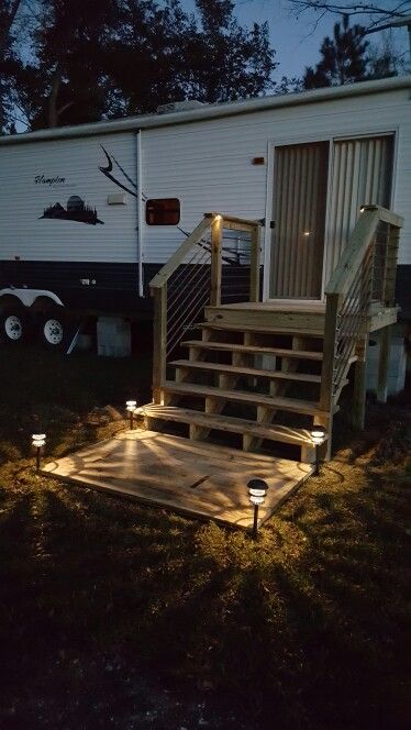 RV deck with landing and rebar railing Rv Steps Ideas, Rv Patio Ideas, Porch For Camper, Campsite Decorating, Camper Steps, Rv Patio, Rv Lots, Camper Trailer Remodel, Trailer Living