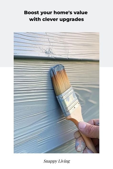 Close-up of a hand holding a paintbrush applying white paint to a house exterior, illustrating home improvement. Raised Homes, Increase Home Value, Different Types Of Fences, Soundproof Room, Simple Projects, Security Tips, Wooden Decks, Cleaners Homemade, Eco Friendly Living