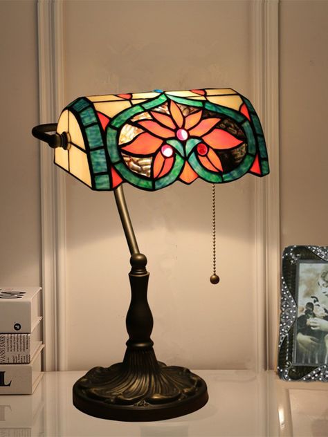 Feature 
 This Tiffany Lamp is a timeless and classic table lamp. The base is made from a durable metal, finished in a beautiful warm bronze tone that exudes vintage chic. The glass lampshade is an exquisite mosaic of stained glass pieces each hand-crafted and designed to create a stunning effect when illuminated. This delicate retro lamp is perfect for setting the mood in your living room. The gentle light creates a cozy and inviting atmosphere, perfect for any decor style. Tiffany Lamps Living Room Decor, Tiffany Lamps Living Room, Stain Glass Lamp, Cozy Lamps, Aesthetic Lamps, Stained Glass Lampshade, Stained Glass Lamp, Classic Table Lamp, Tiffany Lamp