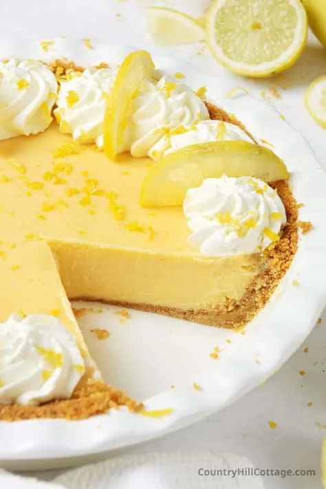 Citrusy condensed milk lemon pie is sweet, tangy, and unbelievably creamy. Made with 6 simple ingredients and a classic graham cracker crust, the lemon pie recipe uses fresh lemon juice and zest for the ultimate lemon flavor. Homemade Creamy lemon pie with sweetened condensed milk is a refreshing summer dessert and a wonderful addition to any holiday pie spread. Baked in a crunchy crust and topped with puffs of fluffy whipped cream, your family will devour it! | CountryHillCottage.com Lemon Pie Recipe Condensed Milk, Gluten Free Key Lime Pie, Easy Lemon Pie, Lemon Icebox Pie, Lemon Pie Recipe, Lemon Treats, Lime Desserts, Lemon Pie Filling, Biscuits Graham