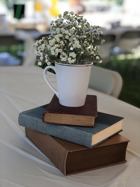 Book Inspired Centerpieces, Bookworm Graduation Party, Vintage Book Party Decor, Baby Shower Book Centerpieces, Vintage Book Themed Party, Book Club Table Decor, Graduation Party Book Theme, On To The Next Chapter Graduation Party, Mug Centerpiece Ideas